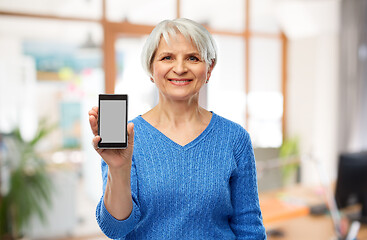 Image showing smiling senior woman showing smartphone