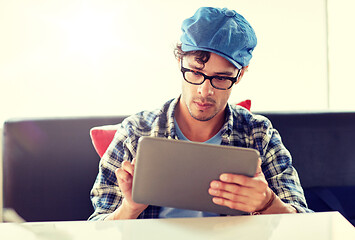 Image showing man with tablet pc sitting at cafe table