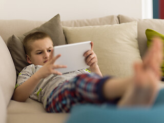 Image showing little boy playing games on tablet computers