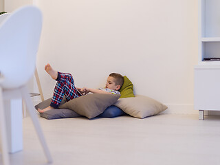 Image showing little boy playing games on tablet computers