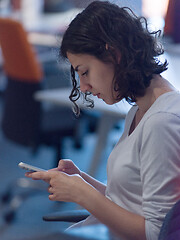 Image showing Businesswoman typing on phone  in office