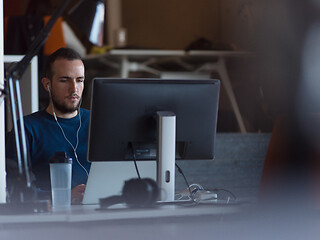 Image showing businessman working using a laptop in startup office