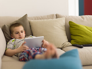 Image showing little boy playing games on tablet computers