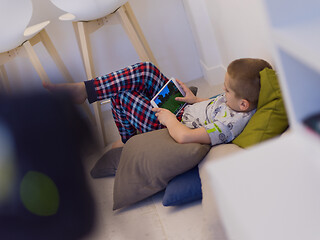 Image showing little boy playing games on tablet computers