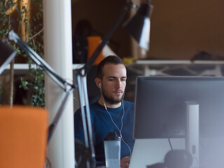 Image showing businessman working using a laptop in startup office