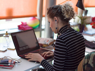 Image showing businesswoman using a laptop in startup office