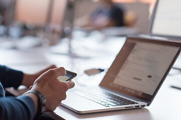 Image showing businessman working using a laptop in startup office