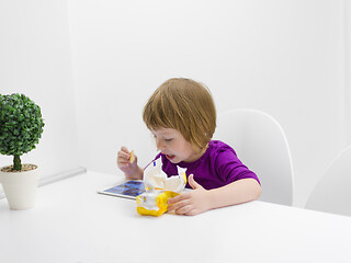 Image showing little girl playing games on tablet computer