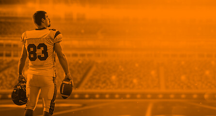 Image showing duo toned american football player in  arena at night