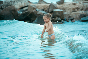 Image showing The happy little girl playing on the beach at the day time