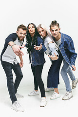 Image showing Group of smiling friends in fashionable jeans