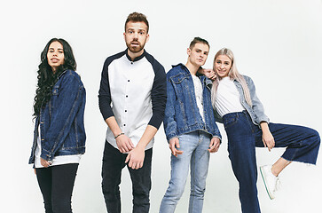 Image showing Group of smiling friends in fashionable jeans