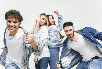 Image showing Group of smiling friends in fashionable jeans