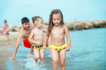 Image showing Two happy children playing on the beach at the day time