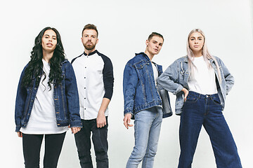 Image showing Group of smiling friends in fashionable jeans