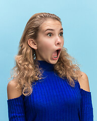 Image showing The woman screaming with open mouth isolated on blue background, concept face emotion