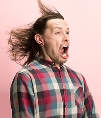 Image showing The man screaming with open mouth isolated on pink background, concept face emotion