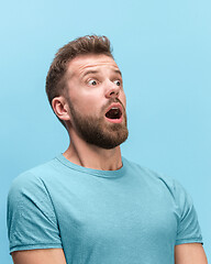 Image showing The man screaming with open mouth isolated on blue background, concept face emotion