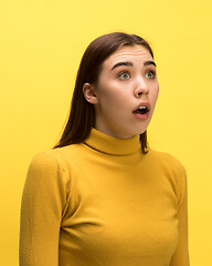 Image showing The woman screaming with open mouth isolated on yellow background, concept face emotion