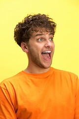 Image showing The man screaming with open mouth isolated on yellow background, concept face emotion