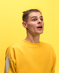 Image showing The man screaming with open mouth isolated on yellow background, concept face emotion