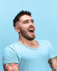 Image showing The man screaming with open mouth isolated on blue background, concept face emotion