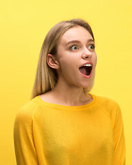 Image showing The woman screaming with open mouth isolated on yellow background, concept face emotion