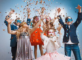 Image showing Adorable kids have fun together, throw colourful confetti,