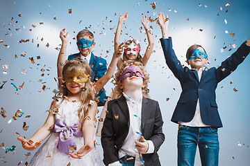 Image showing Adorable kids have fun together, throw colourful confetti,