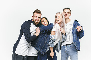 Image showing Group of smiling friends in fashionable jeans