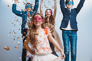 Image showing Adorable kids have fun together, throw colourful confetti,