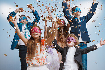 Image showing Adorable kids have fun together, throw colourful confetti,