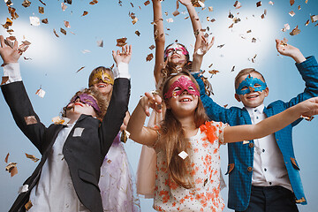 Image showing Adorable kids have fun together, throw colourful confetti,