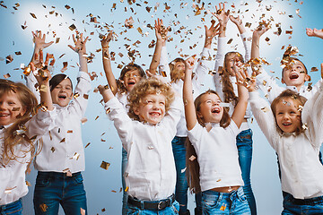 Image showing Adorable kids have fun together, throw colourful confetti,