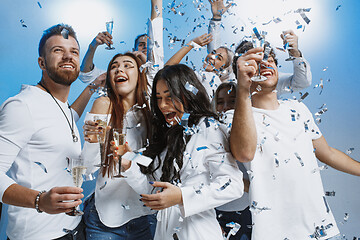 Image showing Group of cheerful joyful young people standing and celebrating t