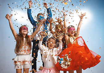 Image showing Adorable kids have fun together, throw colourful confetti,