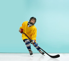 Image showing A hockey player with equipment over a blue background