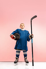 Image showing A hockey player with equipment over a pink background