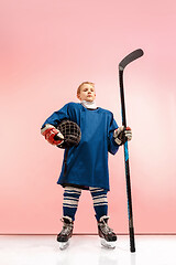 Image showing A hockey player with equipment over a pink background