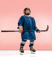 Image showing A hockey player with equipment over a pink background