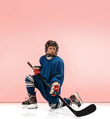 Image showing A hockey player with equipment over a pink background