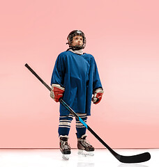 Image showing A hockey player with equipment over a pink background