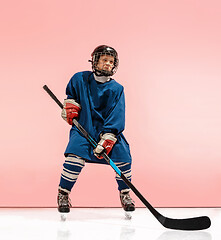 Image showing A hockey player with equipment over a pink background