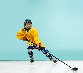 Image showing A hockey player with equipment over a blue background