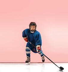 Image showing A hockey player with equipment over a pink background