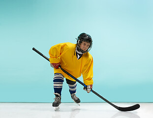 Image showing A hockey player with equipment over a blue background