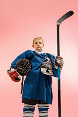 Image showing A hockey player with equipment over a pink background