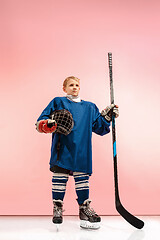 Image showing A hockey player with equipment over a pink background