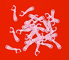 Image showing Floss toothpicks isolated on red background