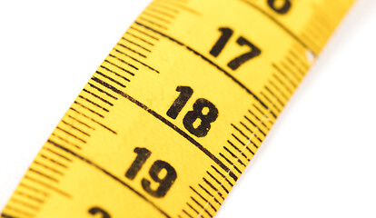 Image showing Close-up of a yellow measuring tape isolated on white - 18